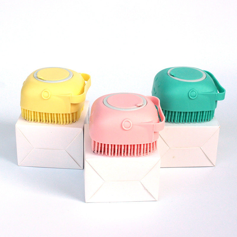 Cat bath brush with silicone bristles and shampoo reservoir.