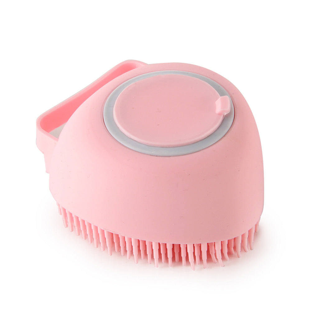 Pet bath brush with built-in soap dispenser for grooming at home.